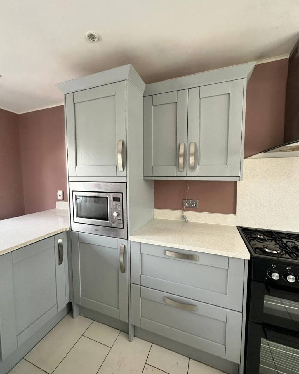 Kitchen units and walls redecorated in one job, the units in grey and the walls in a dusky pink