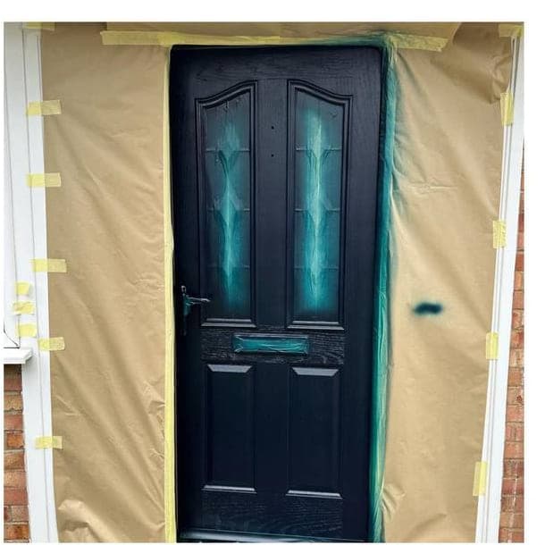 The same door mid job, with the opening papered and taped off before spraying